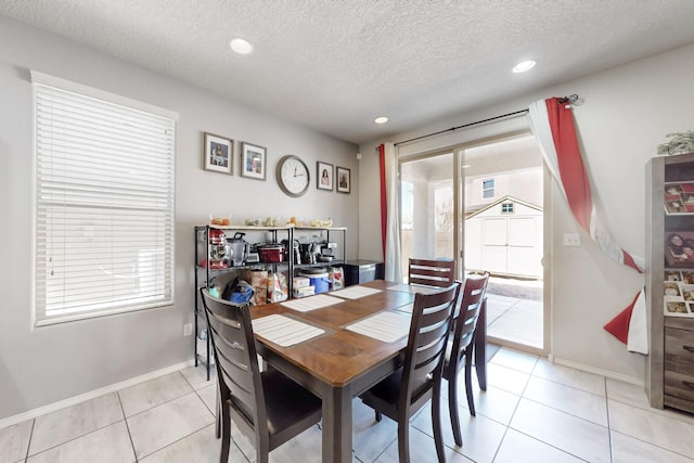 dining room with light tile patterned floors, recessed lighting, baseboards, and a textured ceiling