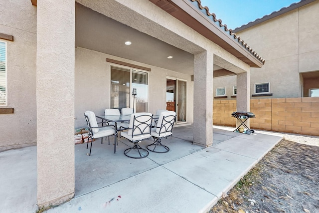 view of patio / terrace with outdoor dining area and fence