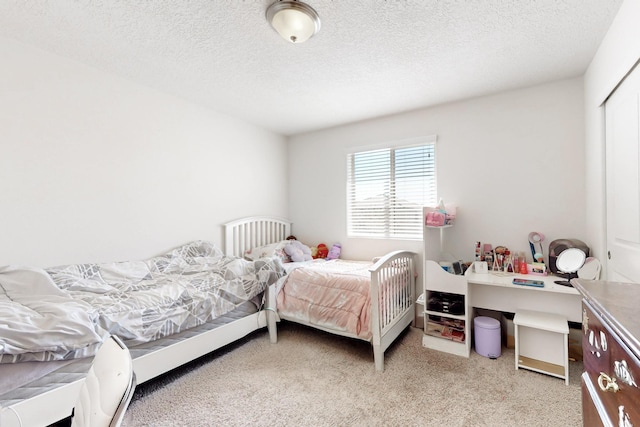 bedroom with a textured ceiling and carpet floors