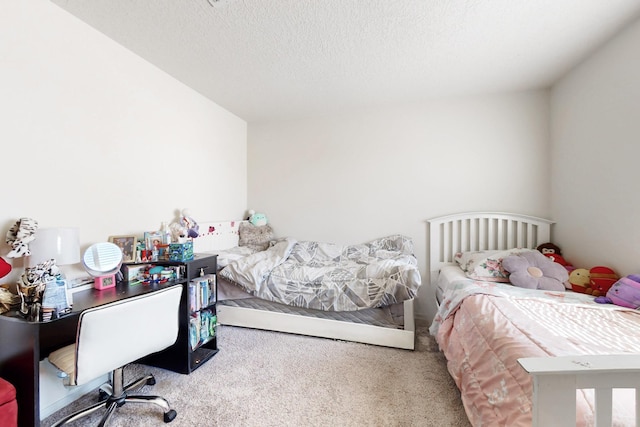 bedroom featuring carpet floors and a textured ceiling