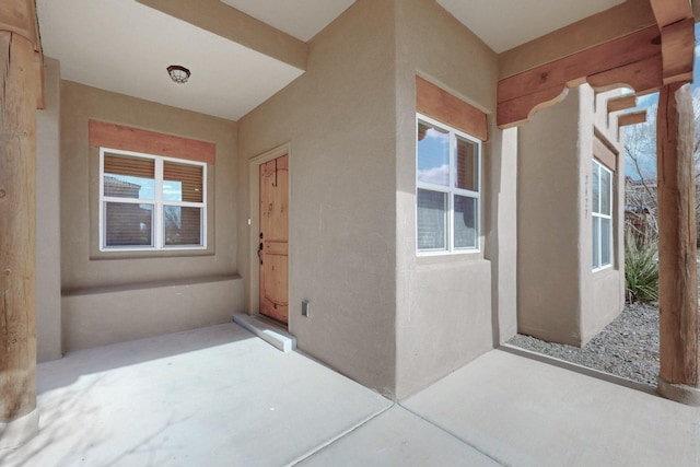 property entrance featuring stucco siding