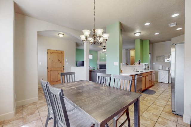 dining space with visible vents, arched walkways, light tile patterned flooring, a fireplace, and recessed lighting