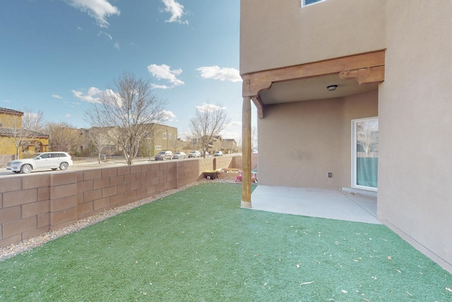 view of yard featuring a patio and fence