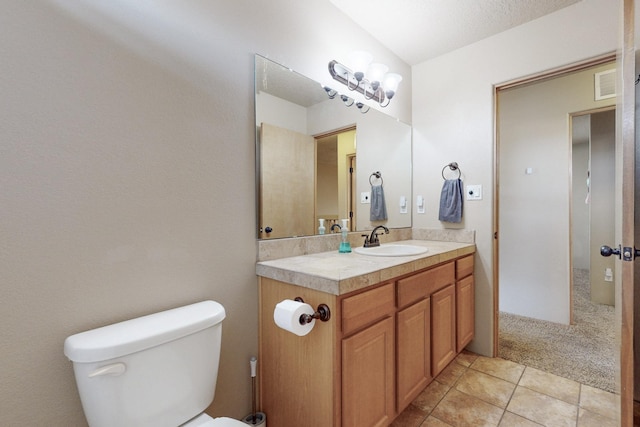 bathroom with toilet, tile patterned flooring, and vanity