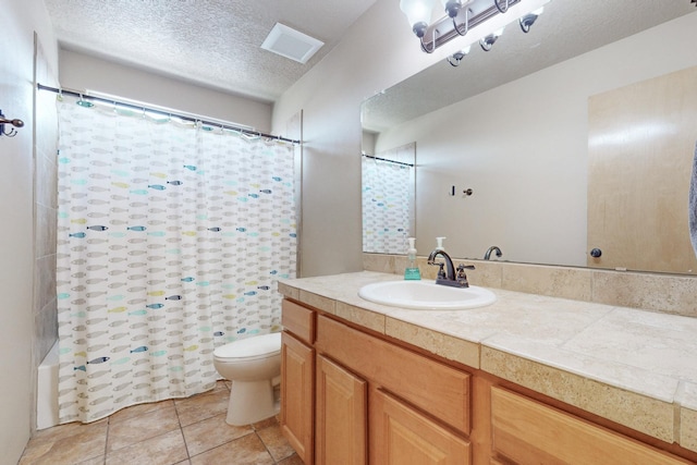 bathroom with visible vents, toilet, a textured ceiling, vanity, and tile patterned floors