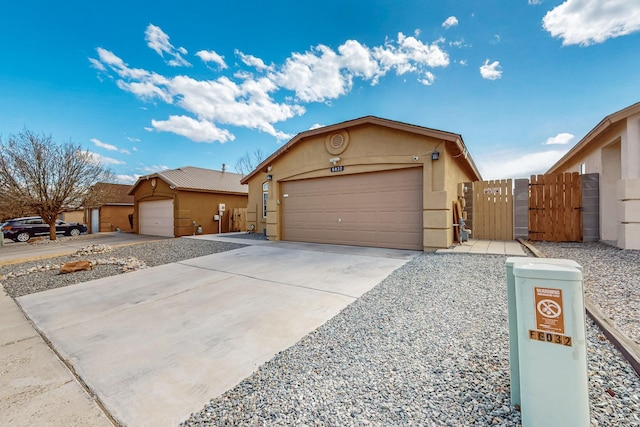 single story home featuring a garage, a gate, fence, and stucco siding