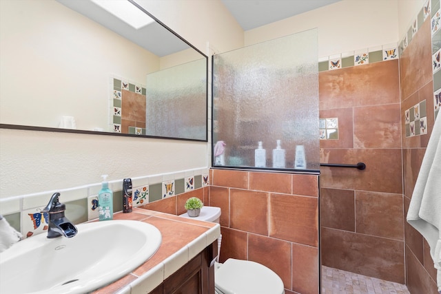 full bathroom with a walk in shower, vanity, and toilet