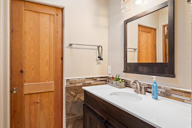 bathroom with wainscoting, vanity, and tile walls