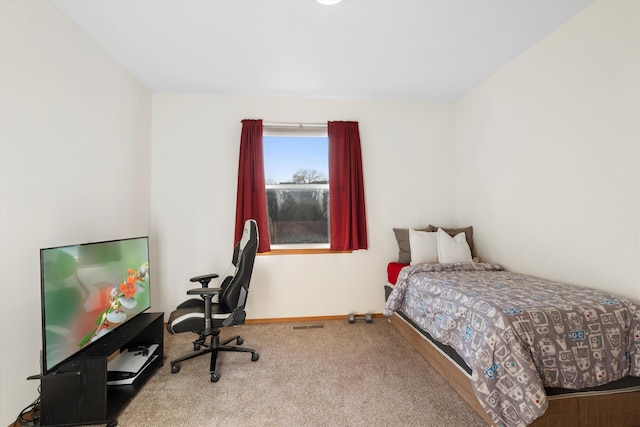 carpeted bedroom featuring baseboards