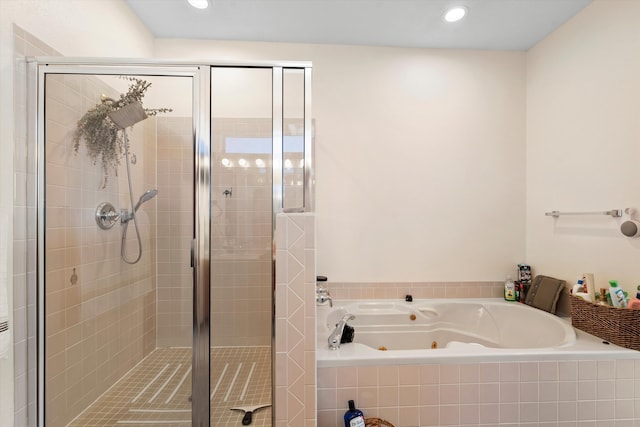 full bath with a shower stall, a tub with jets, and recessed lighting