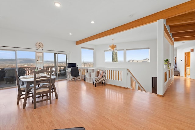 dining space with recessed lighting, beamed ceiling, and wood finished floors