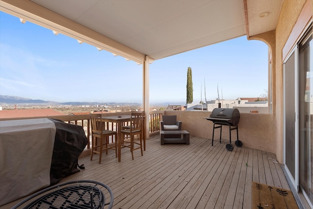 wooden terrace with a grill