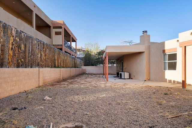 view of yard with fence and a patio