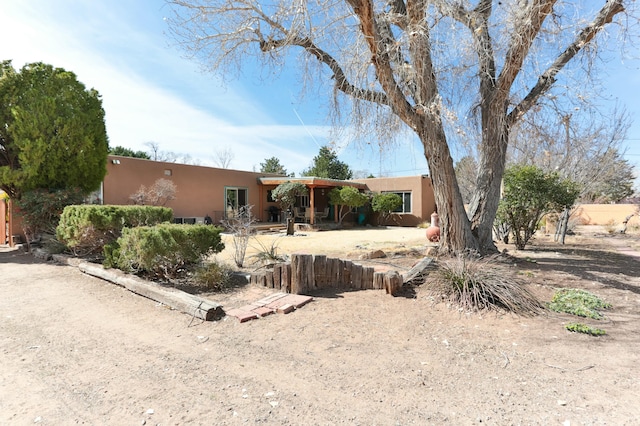 627 Fairway Rd NW, Albuquerque, NM 87107 - pueblo-style home with stucco siding