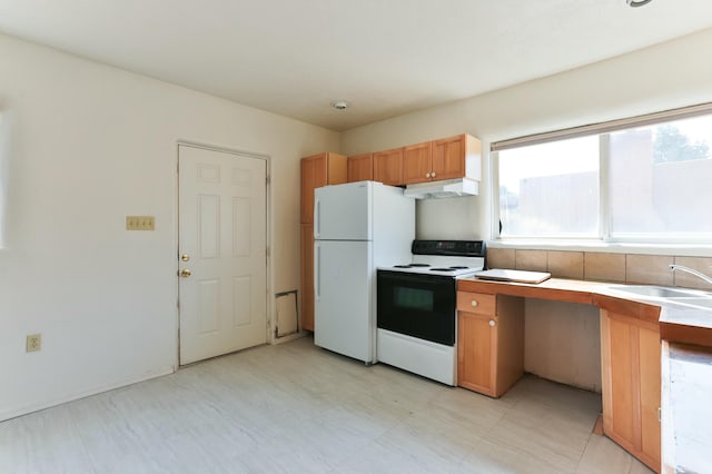 627 Fairway Rd NW, Albuquerque, NM 87107 - kitchen with white appliances, under cabinet range hood, brown cabinets, light countertops, and light flooring