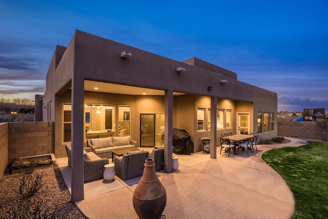 back of property with outdoor lounge area, a patio, a fenced backyard, and stucco siding