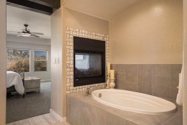 bathroom featuring a garden tub, connected bathroom, baseboards, and ceiling fan