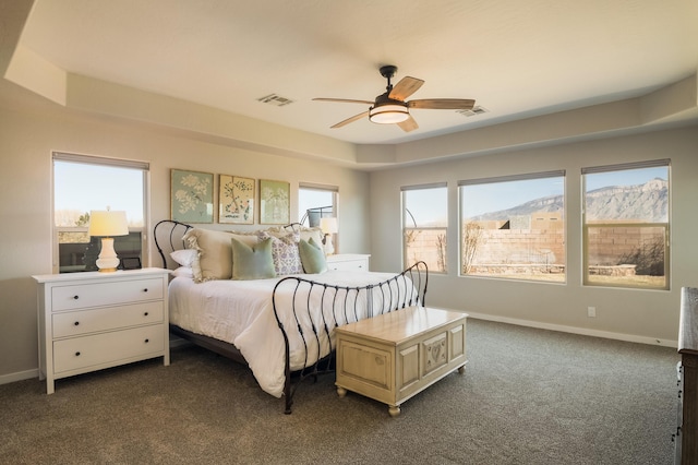 bedroom with dark carpet, visible vents, and baseboards