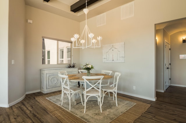 dining space featuring a notable chandelier, wood finished floors, visible vents, and baseboards