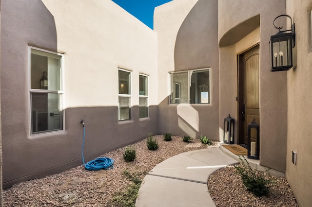 property entrance with stucco siding