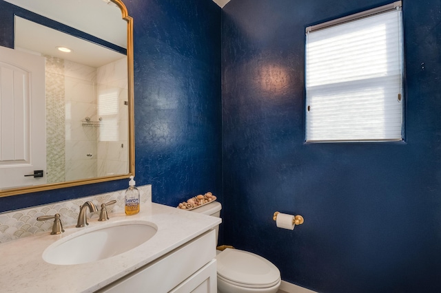 full bath with a textured wall, walk in shower, vanity, and toilet