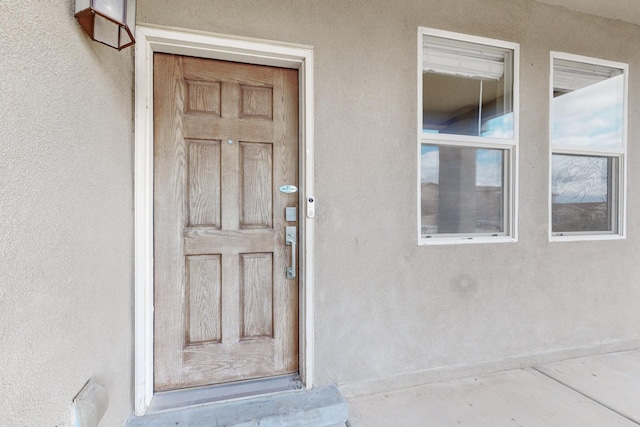 property entrance featuring stucco siding