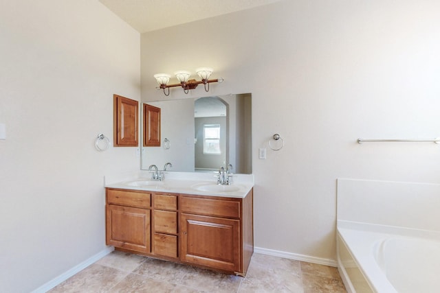 bathroom featuring a sink, baseboards, a bath, and double vanity