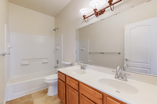 bathroom with a textured ceiling, tile patterned floors, toilet, and a sink