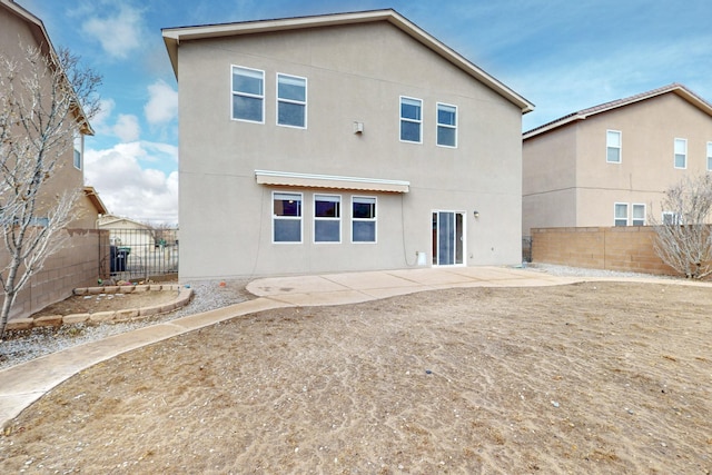 back of property featuring a patio area, stucco siding, and a fenced backyard