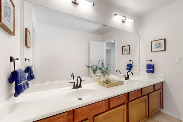 full bathroom with a sink, baseboards, double vanity, and tile patterned floors