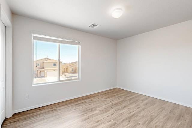 unfurnished room with visible vents, baseboards, and light wood-style flooring