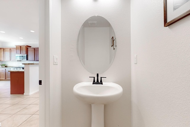 bathroom featuring tile patterned flooring and recessed lighting