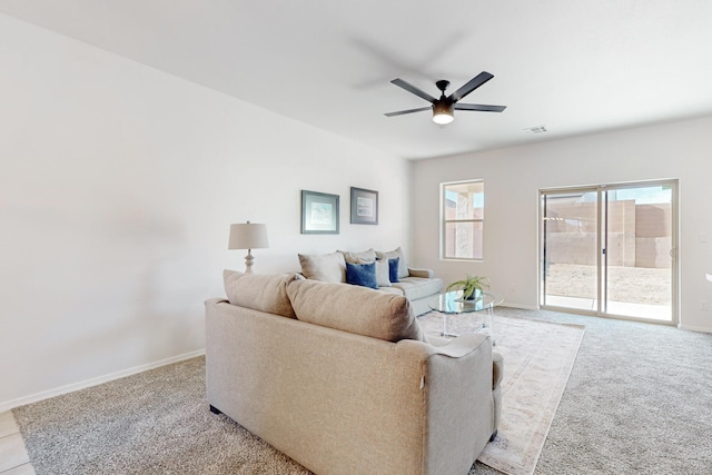 living room with light colored carpet, baseboards, visible vents, and ceiling fan