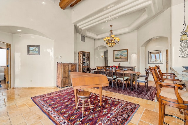 dining room with arched walkways, visible vents, a towering ceiling, and stone tile floors