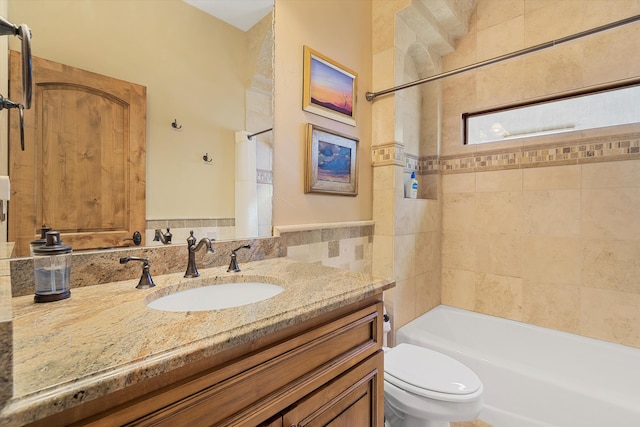 bathroom with shower / bathing tub combination, vanity, and toilet