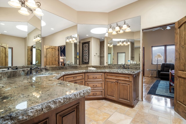 bathroom with double vanity, a sink, and a notable chandelier