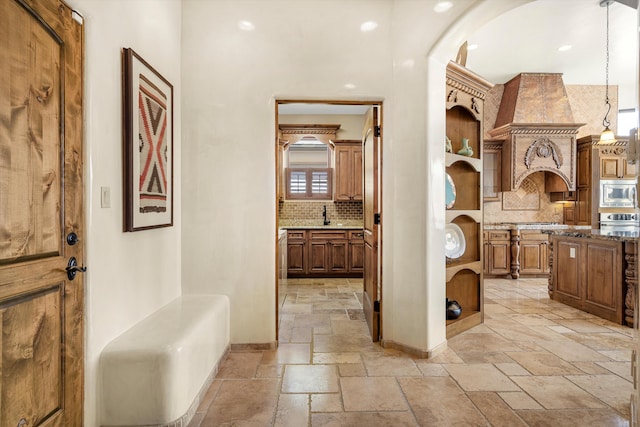 interior space featuring baseboards and stone tile floors