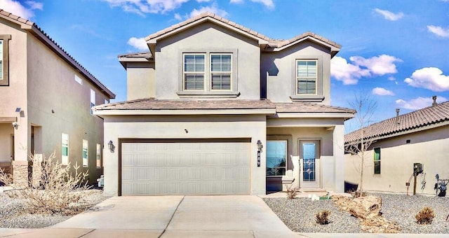 view of front of property with stucco siding, concrete driveway, an attached garage, and a tiled roof