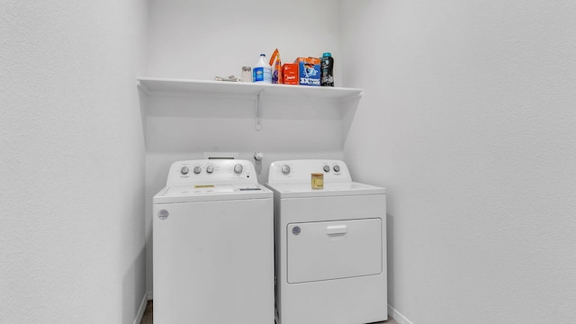 clothes washing area featuring independent washer and dryer and laundry area