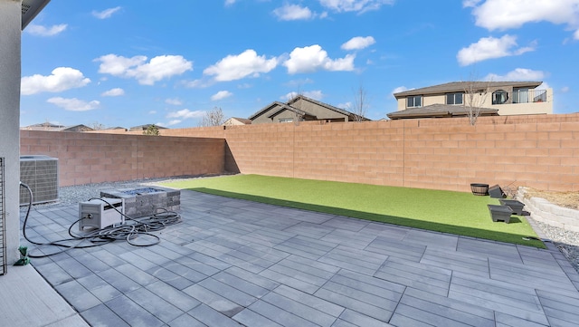 889 Tazanita Loop SE, Rio Rancho, NM 87124 - view of patio featuring central AC unit, a fenced backyard, and an outdoor fire pit