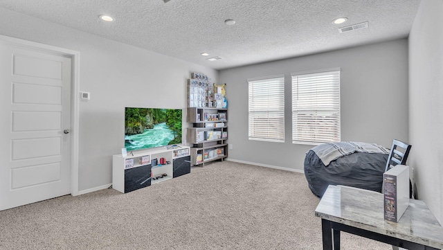 carpeted home office with visible vents, a textured ceiling, and baseboards