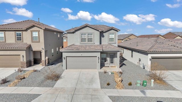 traditional-style home featuring stucco siding, driveway, and a tile roof