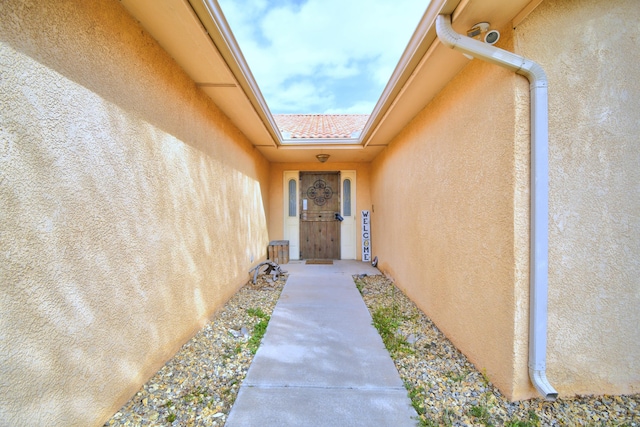 property entrance with stucco siding