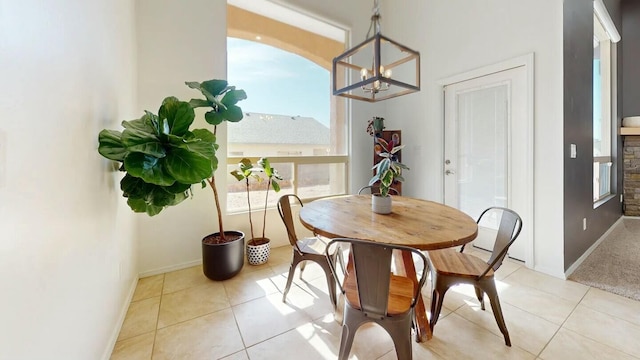 dining space with light tile patterned floors and baseboards