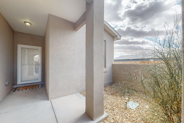 entrance to property with stucco siding