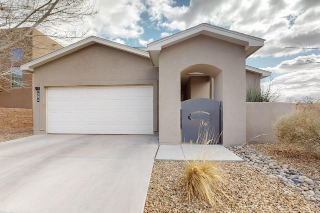 view of front of property with a garage, driveway, and stucco siding