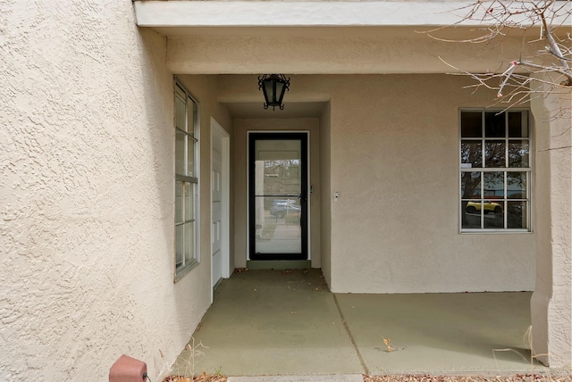 entrance to property with stucco siding