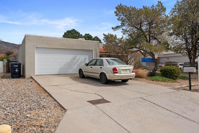 southwest-style home with a detached garage and stucco siding