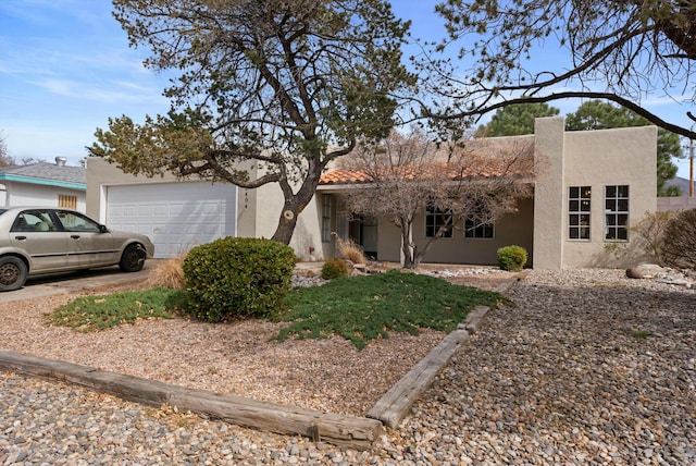 view of front of home with a garage and stucco siding