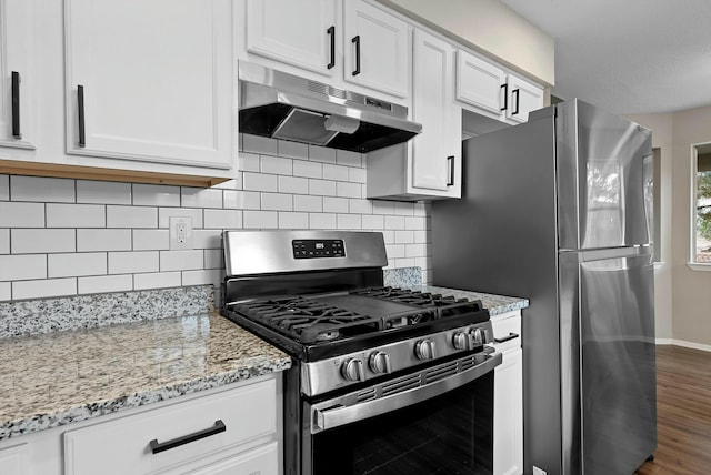 kitchen featuring appliances with stainless steel finishes, backsplash, white cabinetry, and under cabinet range hood